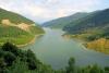 Lake between the hills - A placid lake between steep, green covered hills