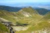 Peaks of a mountain embrace an ice cold, crystal clear pond. - A tiny pond in the mountains