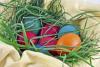 Colorful Easter eggs in a basket and grass nest - Easter eggs in a nest