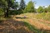 Little girl sitting in the shadow of a tree on the field - Resting on the meadow