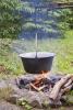 Cooking outdoors in a cauldron - Cauldron over the fire