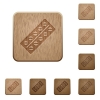 Batch of pills in blister pack on rounded square carved wooden button styles - Batch of pills in blister pack wooden buttons