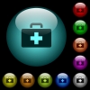 First aid kit icons in color illuminated glass buttons - First aid kit icons in color illuminated spherical glass buttons on black background. Can be used to black or dark templates