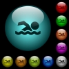 Swimming man icons in color illuminated spherical glass buttons on black background. Can be used to black or dark templates - Swimming man icons in color illuminated glass buttons