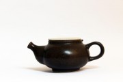 Pitchers and tea soaking useful for warming - a small brown enamel teapot