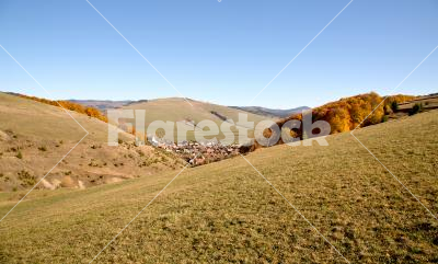 Bare hills - View of a village among hills in autumn 